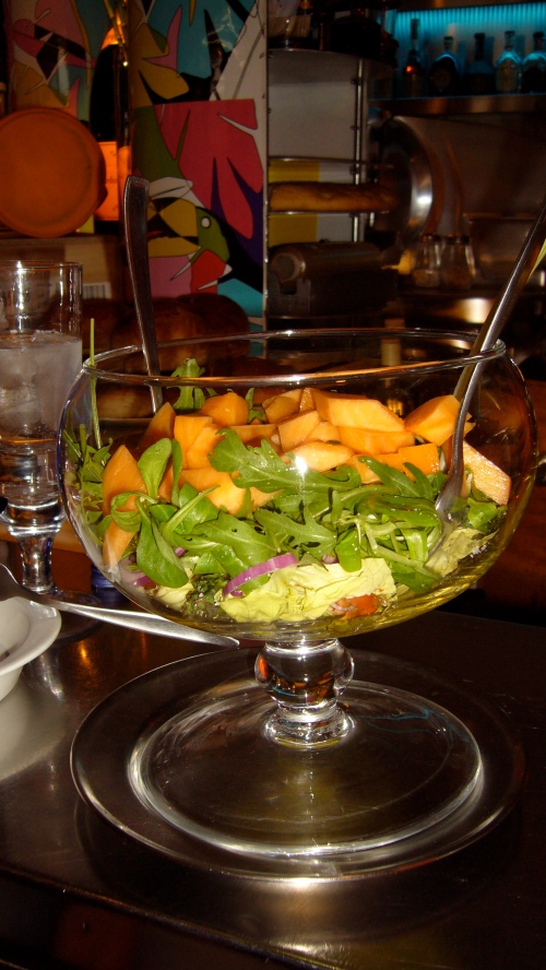 Veggie salad with cantaloupe, butter lettuce, arugula, heirloom tomatoes, red onion, basil, salt, pepper and Ringo's special mustard with extra virgin and aceto red wine vinegar served in a fish bowl