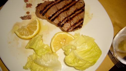 Grilled steak with lemon