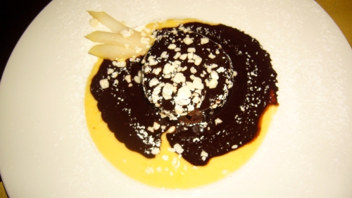 Chocolate cake with cream and chocolate sauce